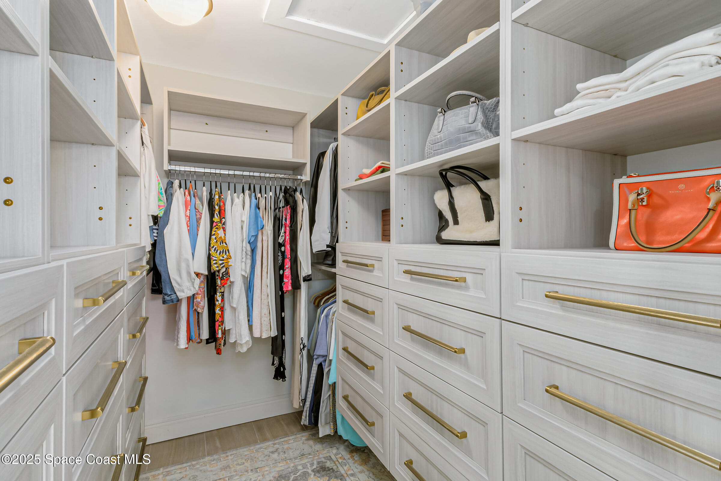 1307 Rockledge Drive Rockledge, FL 32955 - Photo 38 of 75 a view of walk in closet with clothes and shoes