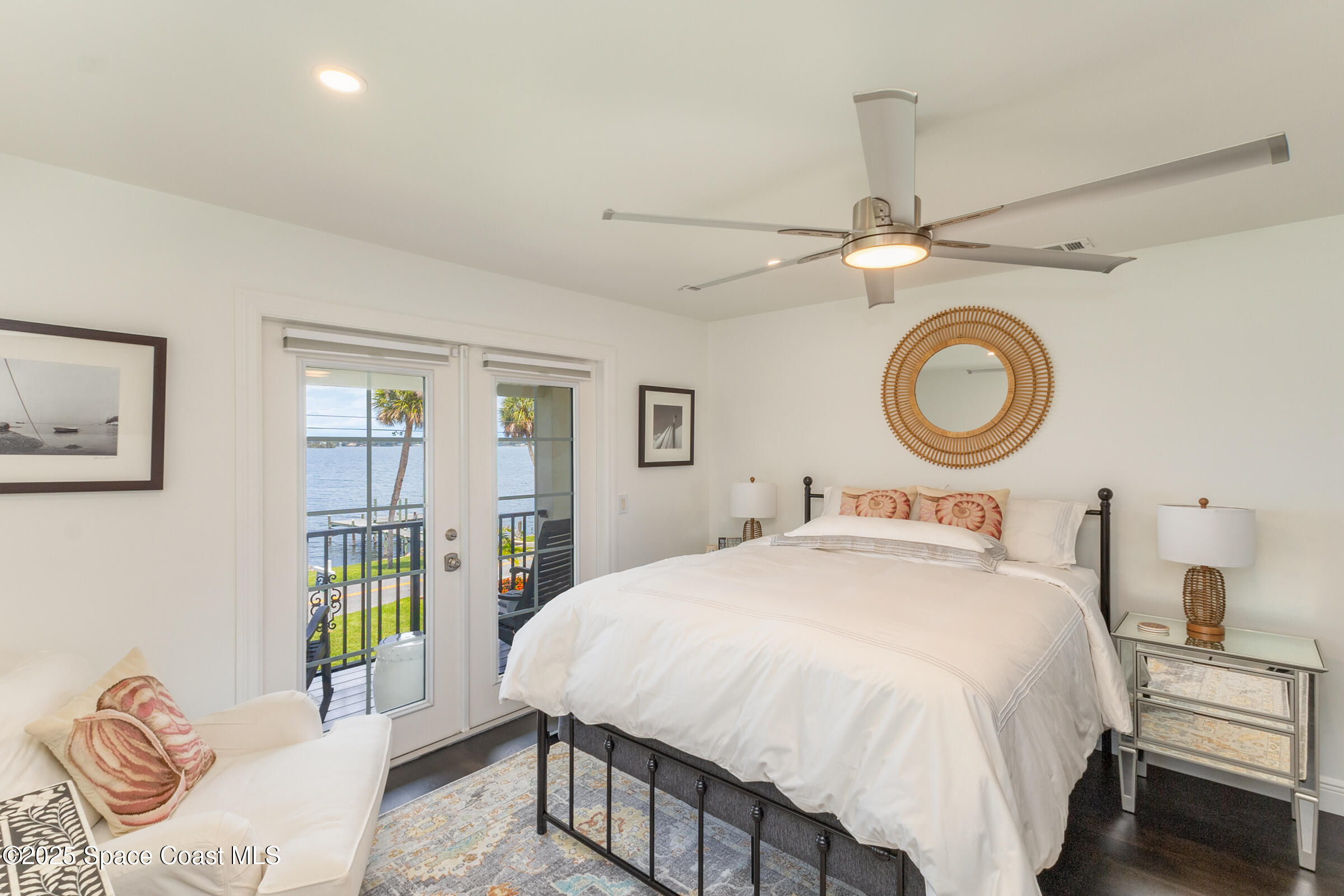 1307 Rockledge Drive Rockledge, FL 32955 - Photo 42 of 75 a bedroom with a bed a clock and a large mirror on the dresser