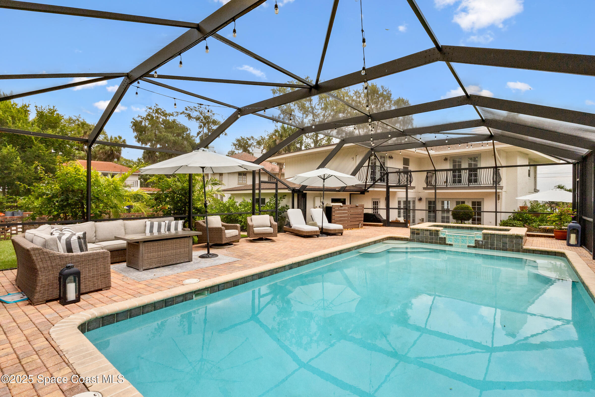 1307 Rockledge Drive Rockledge, FL 32955 - Photo 54 of 75 a view of a backyard with a table and chairs under an umbrella