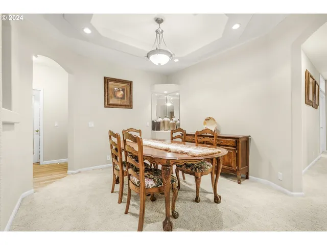 a view of a dining room with furniture and a chandelier