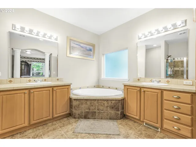 a bathroom with a sink mirror and a bathtub