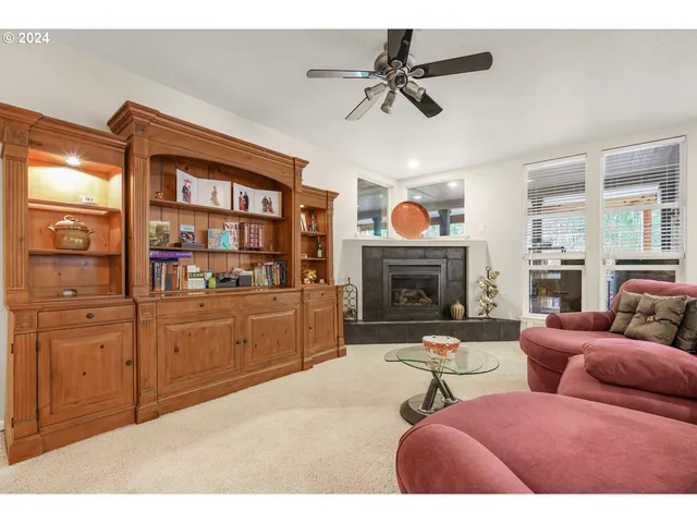 a living room with furniture a fireplace and a chandelier