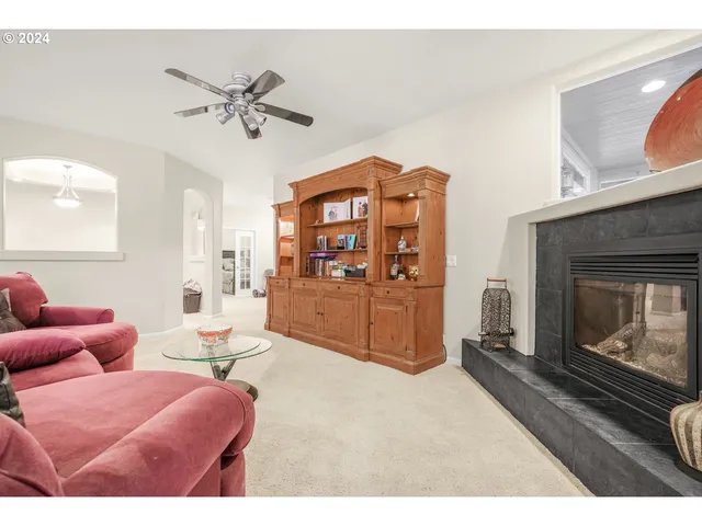 a living room with furniture a fireplace and a flat screen tv