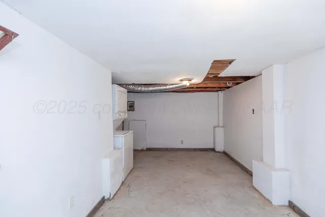 a view of a livingroom with furniture and staircase