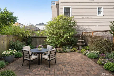 a backyard of a house with a yard and outdoor seating