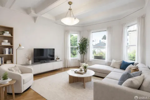 a living room with furniture a flat screen tv and a large window