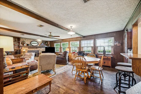a dining room with furniture wooden floor and a rug