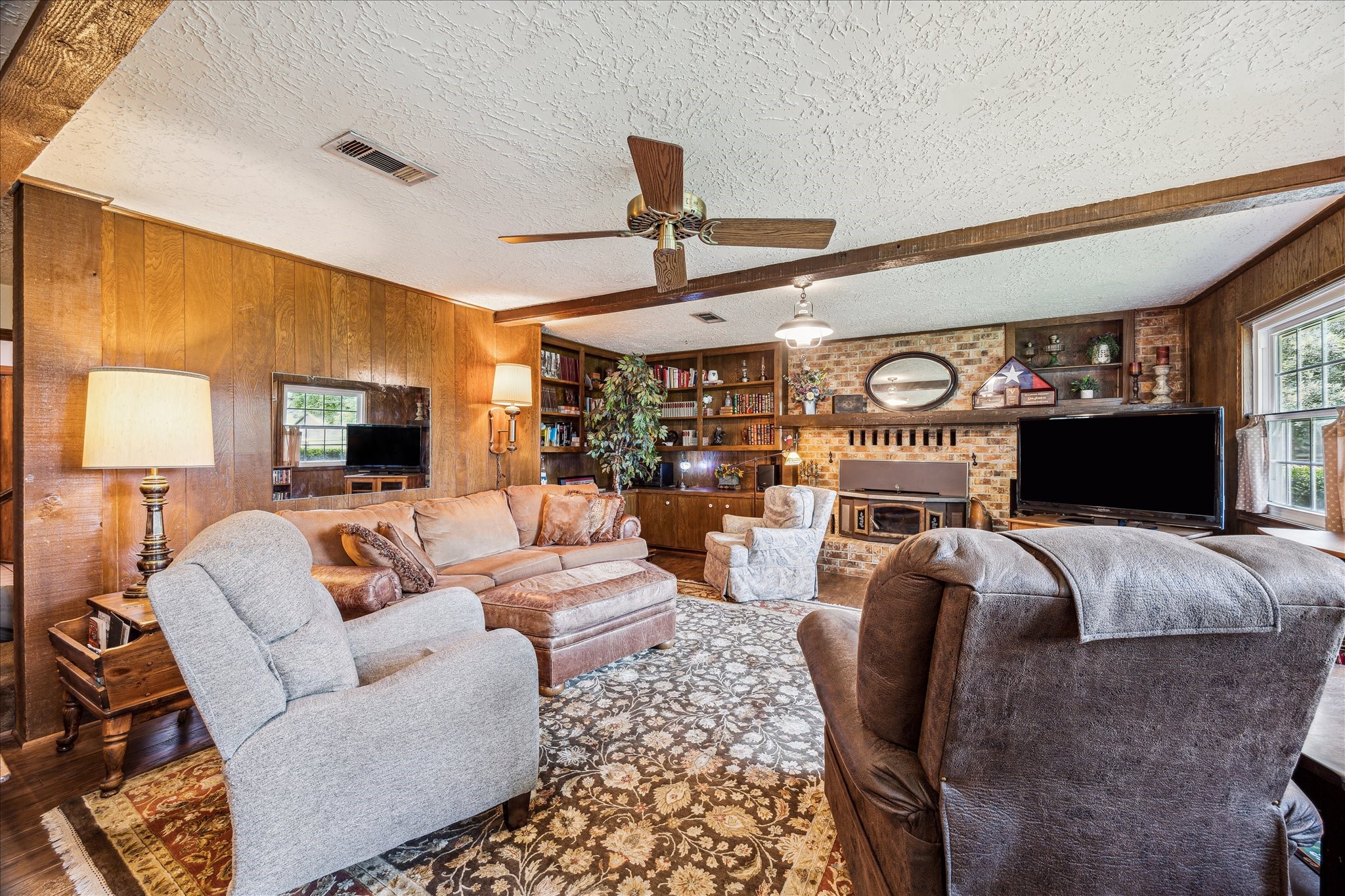 17814 Seidel Cemetary Road Tomball, TX 77377 - Photo 13 of 30 a living room with furniture a fireplace and a flat screen tv