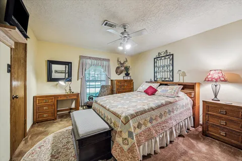 a bedroom with a bed and dresser with mirror