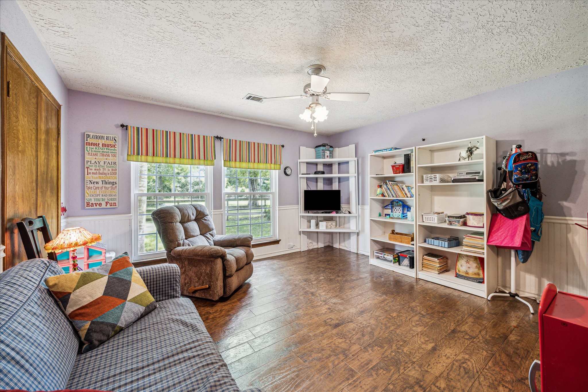 17814 Seidel Cemetary Road Tomball, TX 77377 - Photo 21 of 30 a living room with furniture cabinets and a flat screen tv