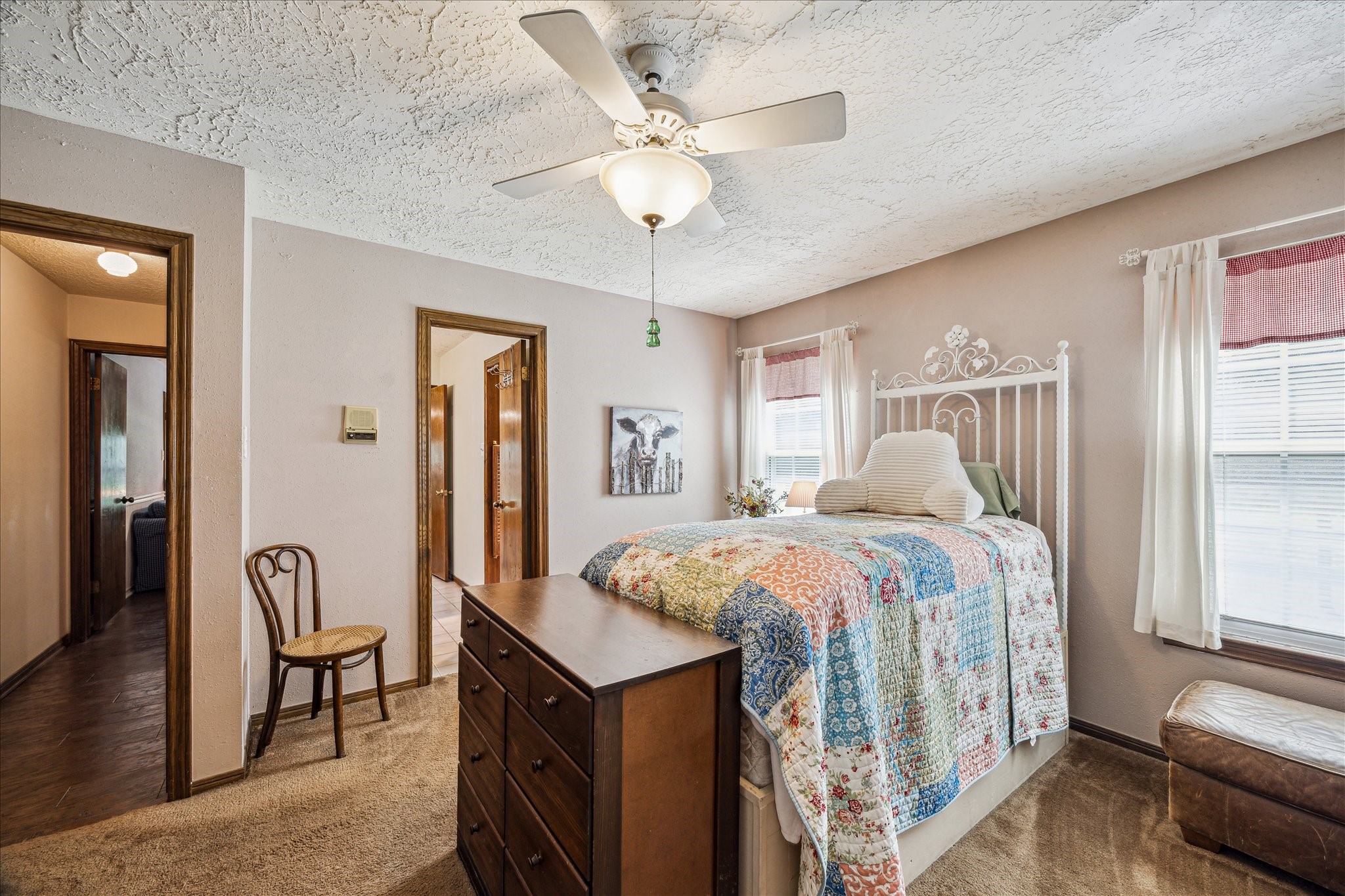 17814 Seidel Cemetary Road Tomball, TX 77377 - Photo 24 of 30 a bedroom with a bed and a chandelier