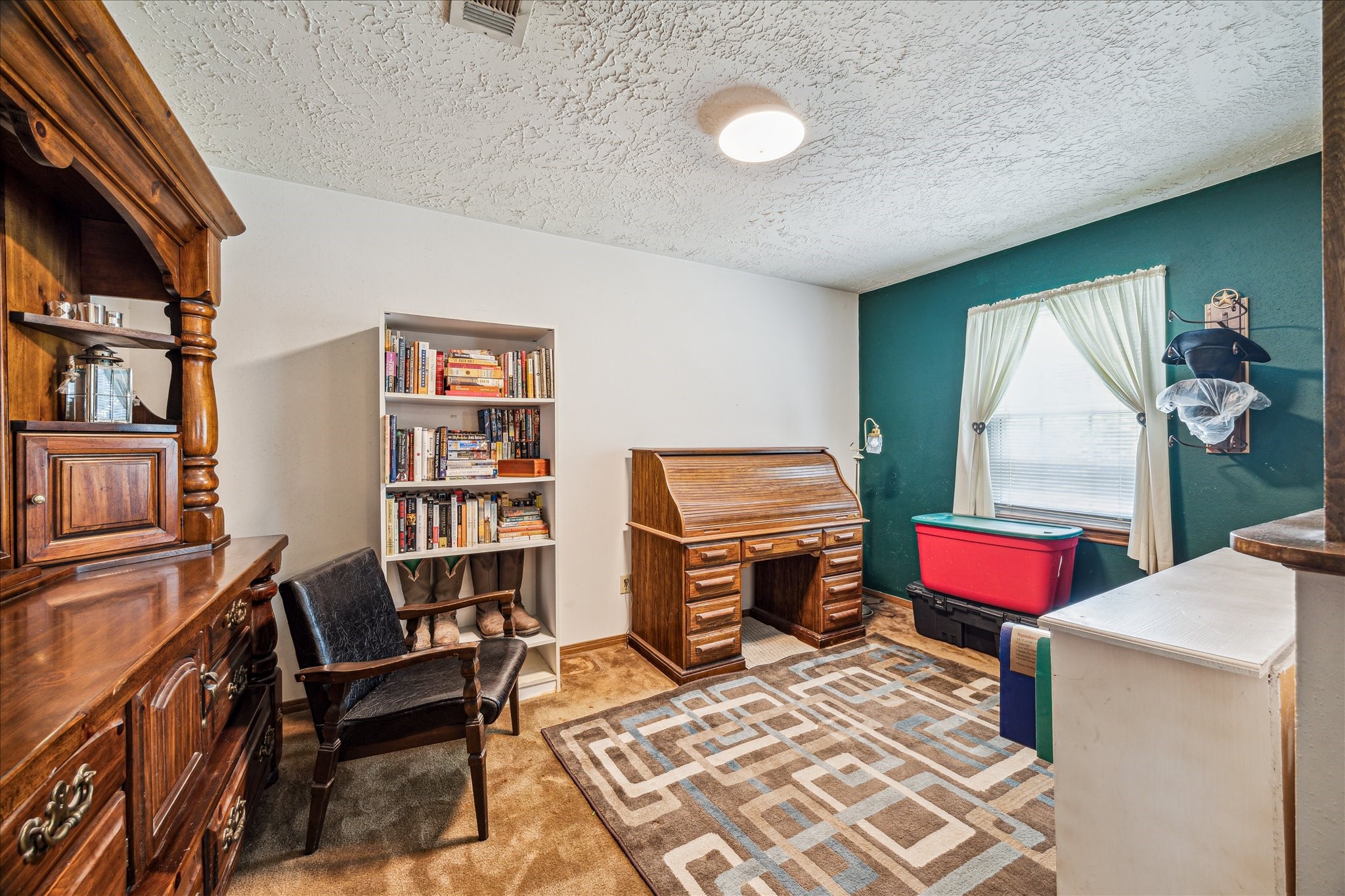 17814 Seidel Cemetary Road Tomball, TX 77377 - Photo 26 of 30 a living room with furniture and a book shelf