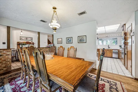 a dining room with furniture a rug and wooden floor