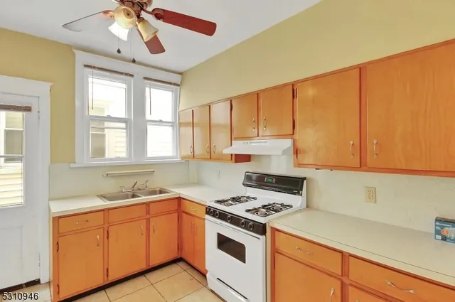 a kitchen with stainless steel appliances granite countertop a sink a stove and a refrigerator
