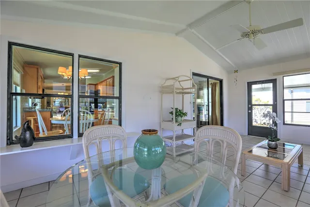 a living room with furniture a chandelier and a large window