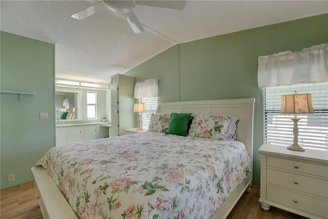 a bedroom with a large bed and a window