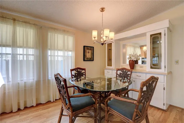 a view of a dining room with furniture wooden floor and chandelier