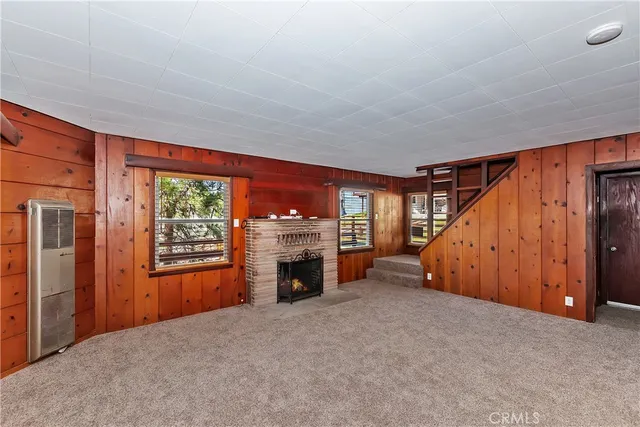 an empty room with furniture and a fireplace