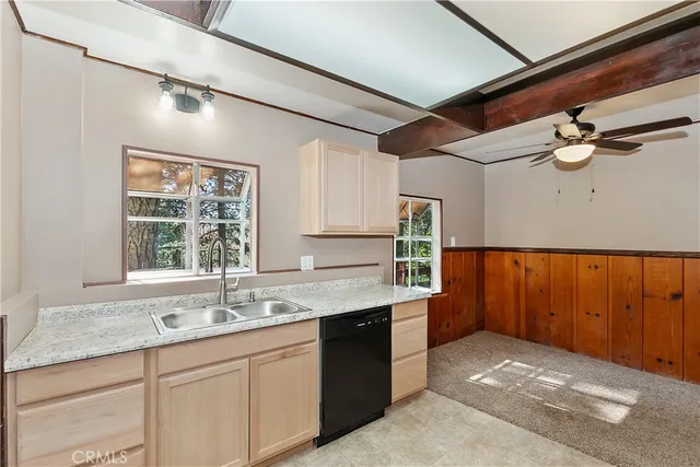 a kitchen with a sink window and cabinets