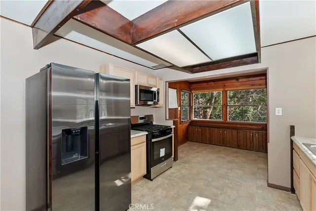 a kitchen with a refrigerator and a stove