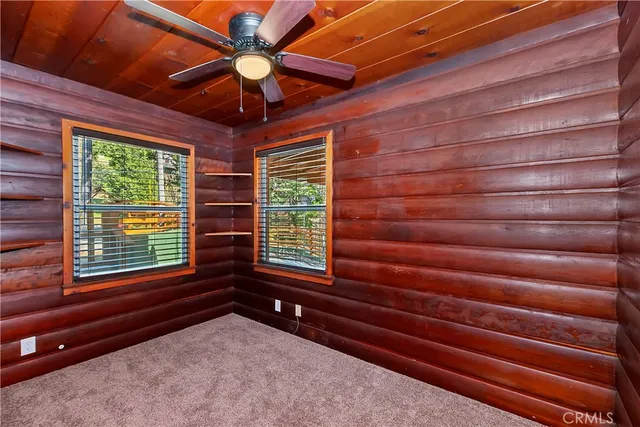 a view of entryway with a ceiling fan and wooden floor