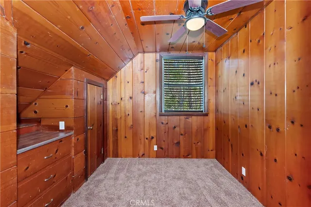 a view of an empty room with a fireplace and a window
