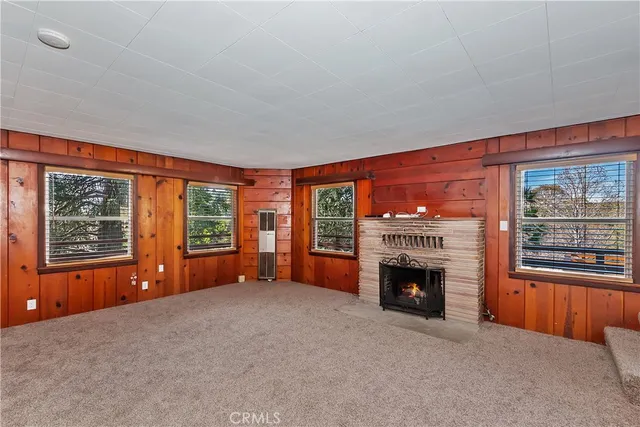 an empty room with furniture and a fireplace