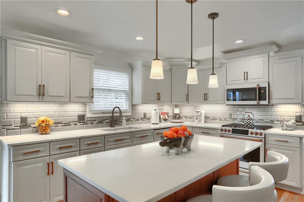 4201 Battle Ridge Road McDonald, PA 15057 - Photo 17 of 50 a kitchen with stainless steel appliances a sink a stove a table and chairs