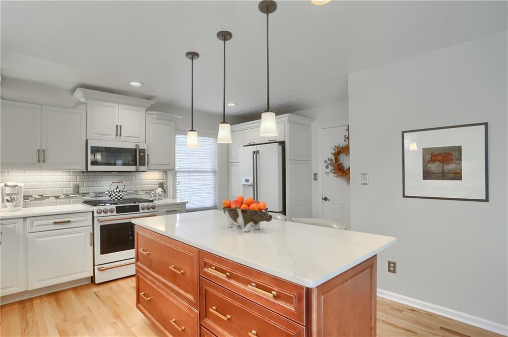 4201 Battle Ridge Road McDonald, PA 15057 - Photo 19 of 50 a kitchen with stainless steel appliances granite countertop a sink a stove and a wooden floor