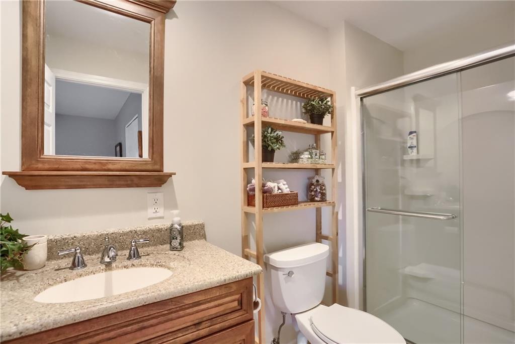 4201 Battle Ridge Road McDonald, PA 15057 - Photo 40 of 50 a bathroom with a granite countertop sink toilet a mirror and shower