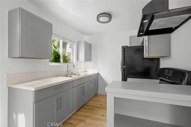 a kitchen with stainless steel appliances a sink a stove and a refrigerator