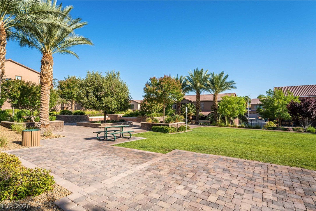 2787 Athens Ridge Drive Henderson, NV 89052 - Photo 31 of 31 A community park with verdant lawns, shaded seating, and mature palm trees for relaxation.