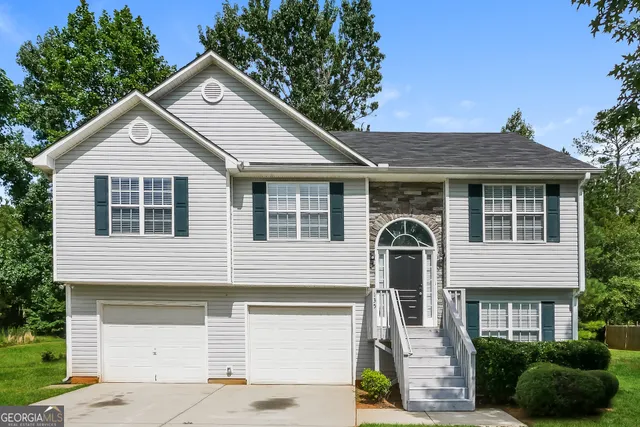 a front view of a house with a yard