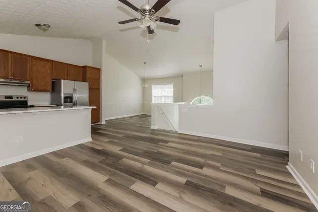 a view of a kitchen with a sink cabinets and wooden floor
