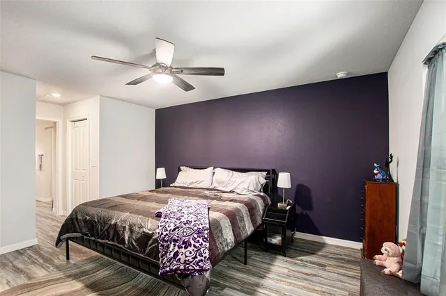 a bedroom with a bed and wooden floor