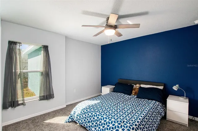 a bedroom with a bed and a window