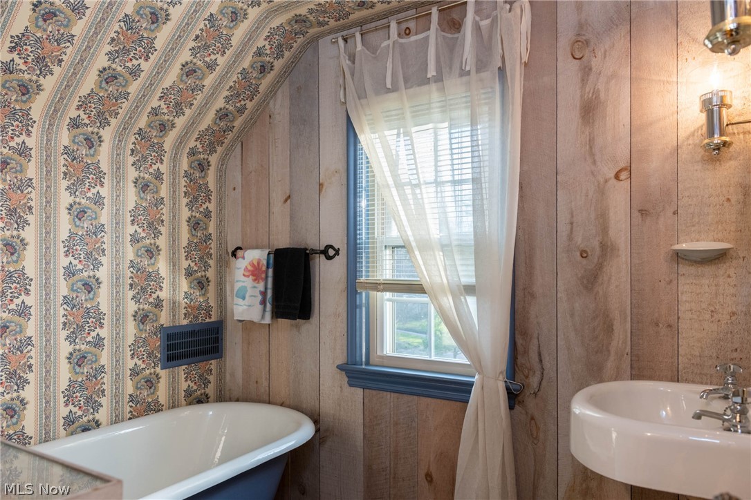 3433 Bradford Road Cleveland, OH 44118 - Photo 24 of 35 The 3rd flr Full bth offers the farm house look, w/ soaking tub/shower hose, long shelf on left(not shown) & pedestal sink. Newer window installed 2017 & fun light fixtures creates a fun bth rm.