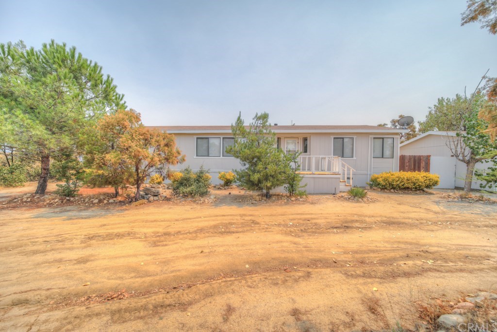 39506 El Toro Road Anza, CA 92539 - Photo 1 of 1 a front view of house with yard and trees around