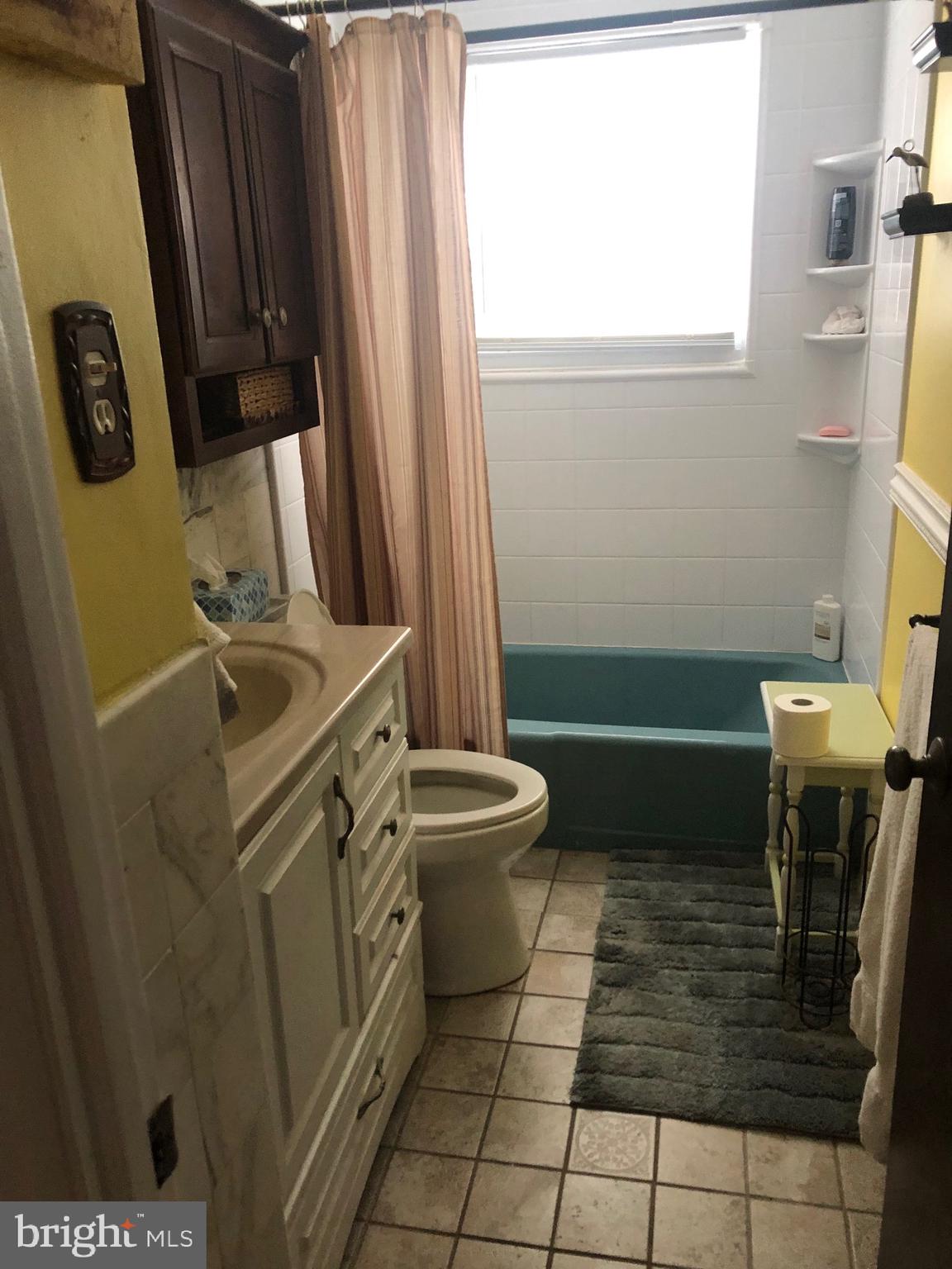 201 Southwood Road Pasadena, MD 21122 - Photo 11 of 16 a bathroom with a sink a toilet and a mirror