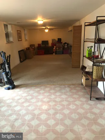 a white toilet sitting next to a white wall