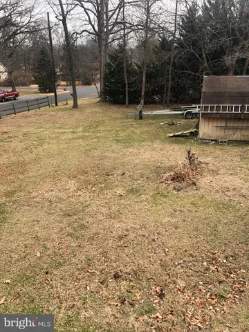 a view of swimming pool with a bench and trees