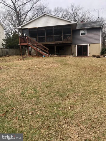 a view of a house with a yard covered with snow
