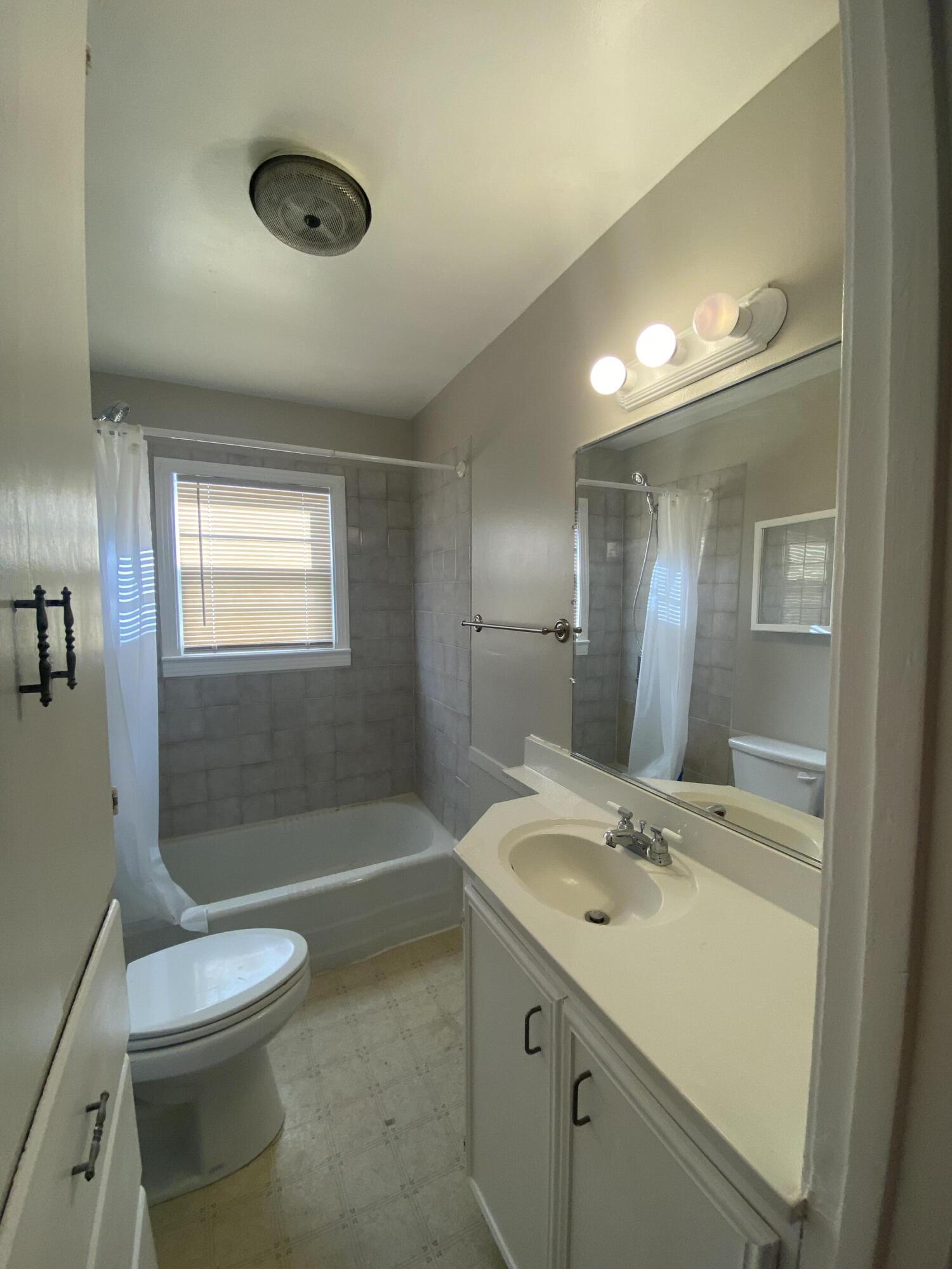 4603 45th Street Lubbock, TX 79414 - Photo 4 of 7 a bathroom with a sink a toilet and shower
