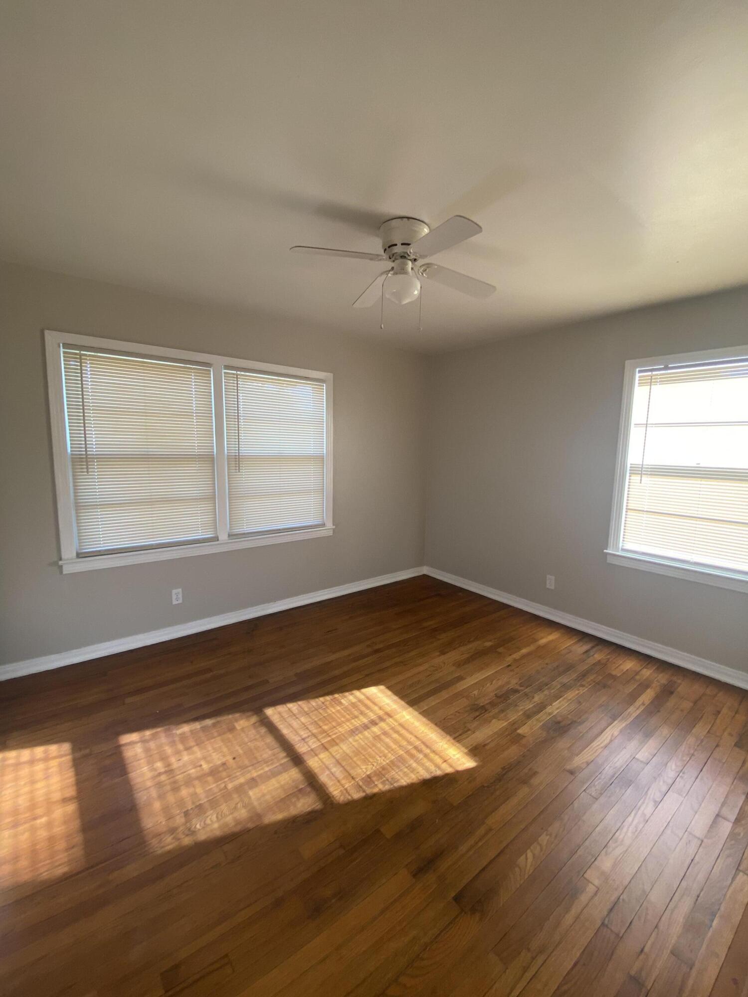 4603 45th Street Lubbock, TX 79414 - Photo 5 of 7 a view of empty room with wooden floor and fan
