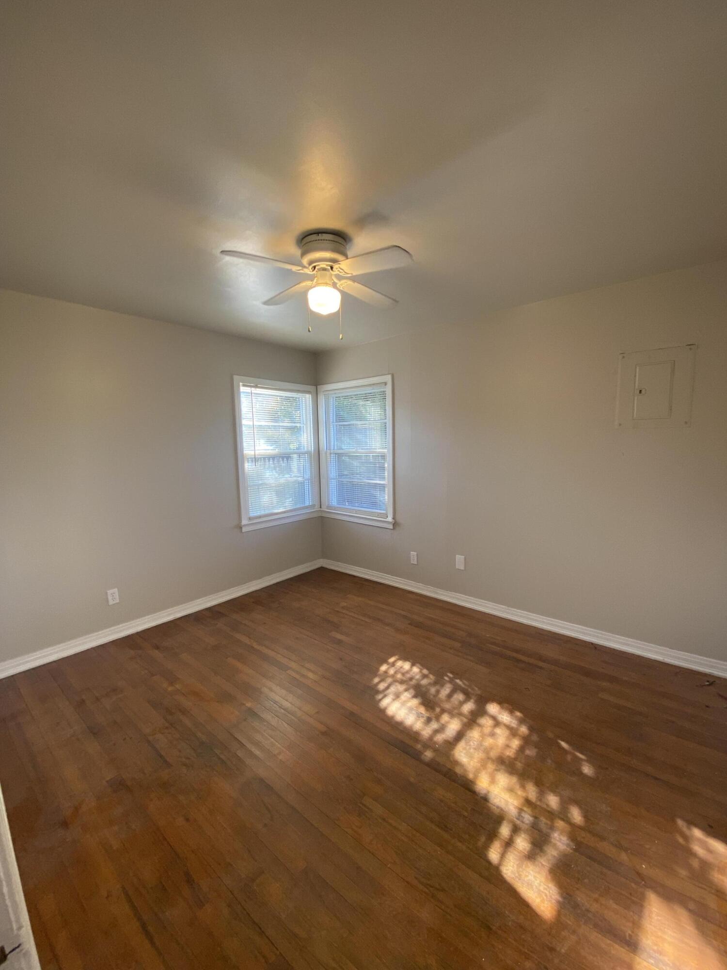 4603 45th Street Lubbock, TX 79414 - Photo 6 of 7 an empty room with wooden floor and windows