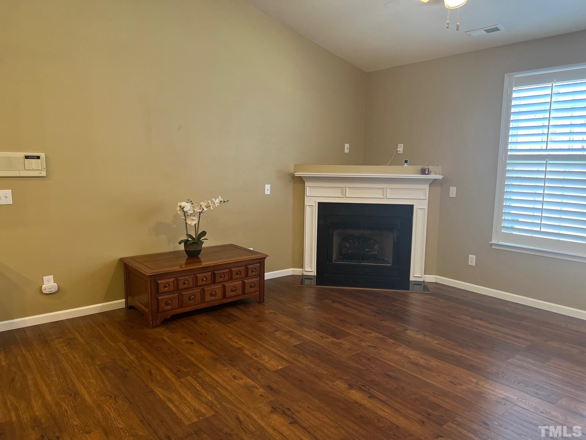 10527 Dapping Drive Raleigh, NC 27614 - Photo 11 of 20 a room with a fireplace and wooden floor