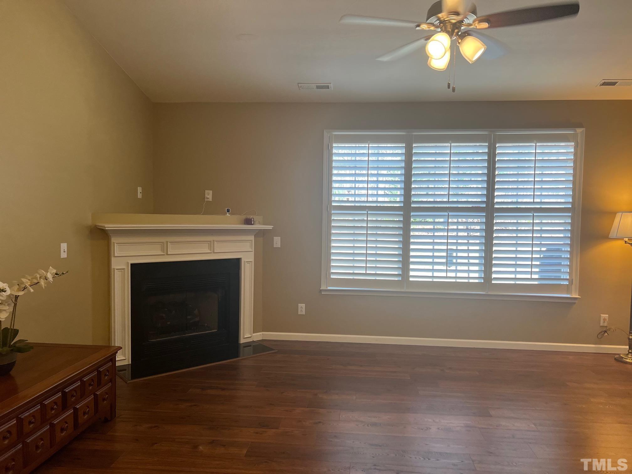 10527 Dapping Drive Raleigh, NC 27614 - Photo 12 of 20 a view of an empty room with a fireplace and a window