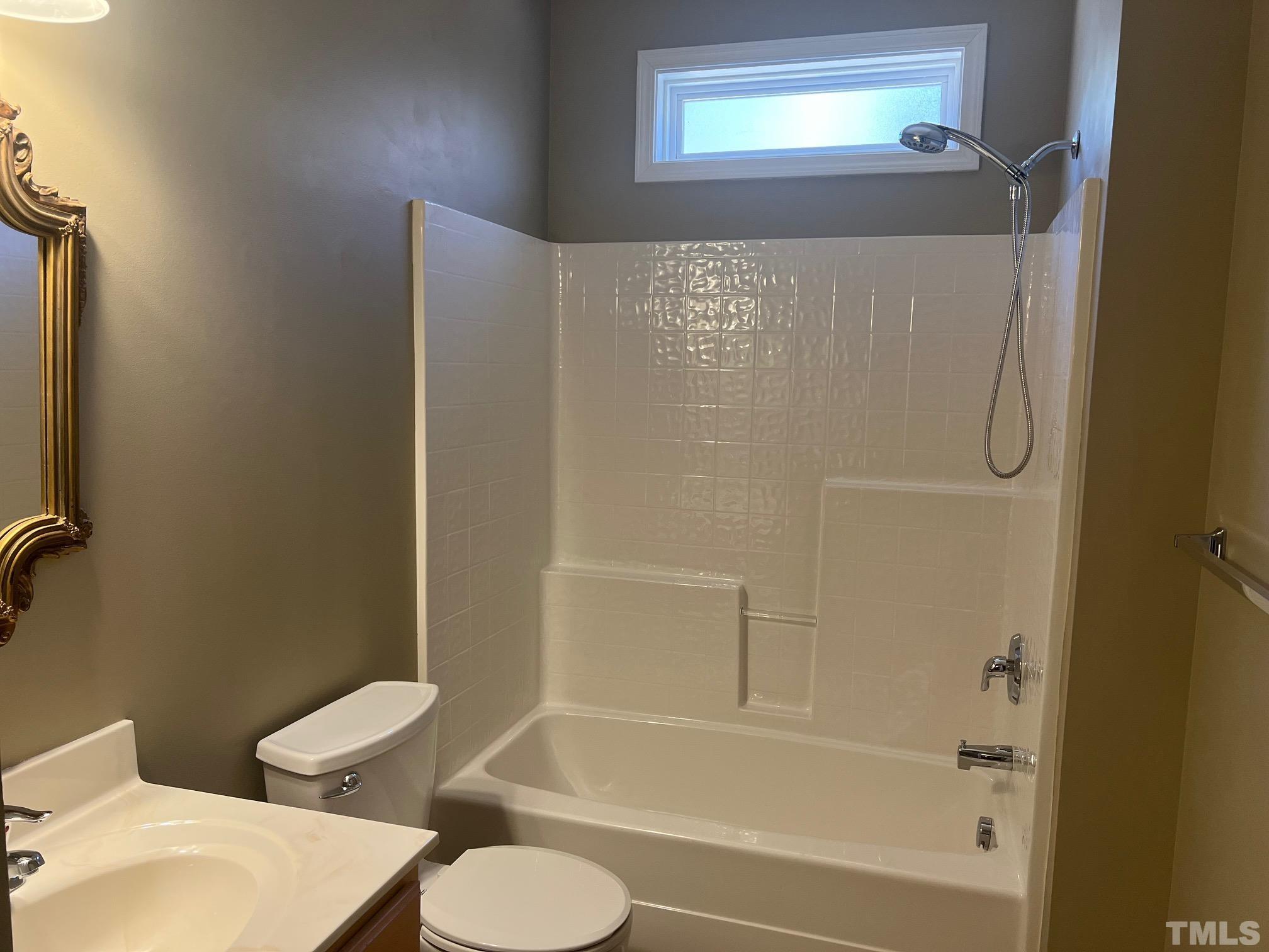 10527 Dapping Drive Raleigh, NC 27614 - Photo 6 of 20 a bathroom with a toilet and a bathtub