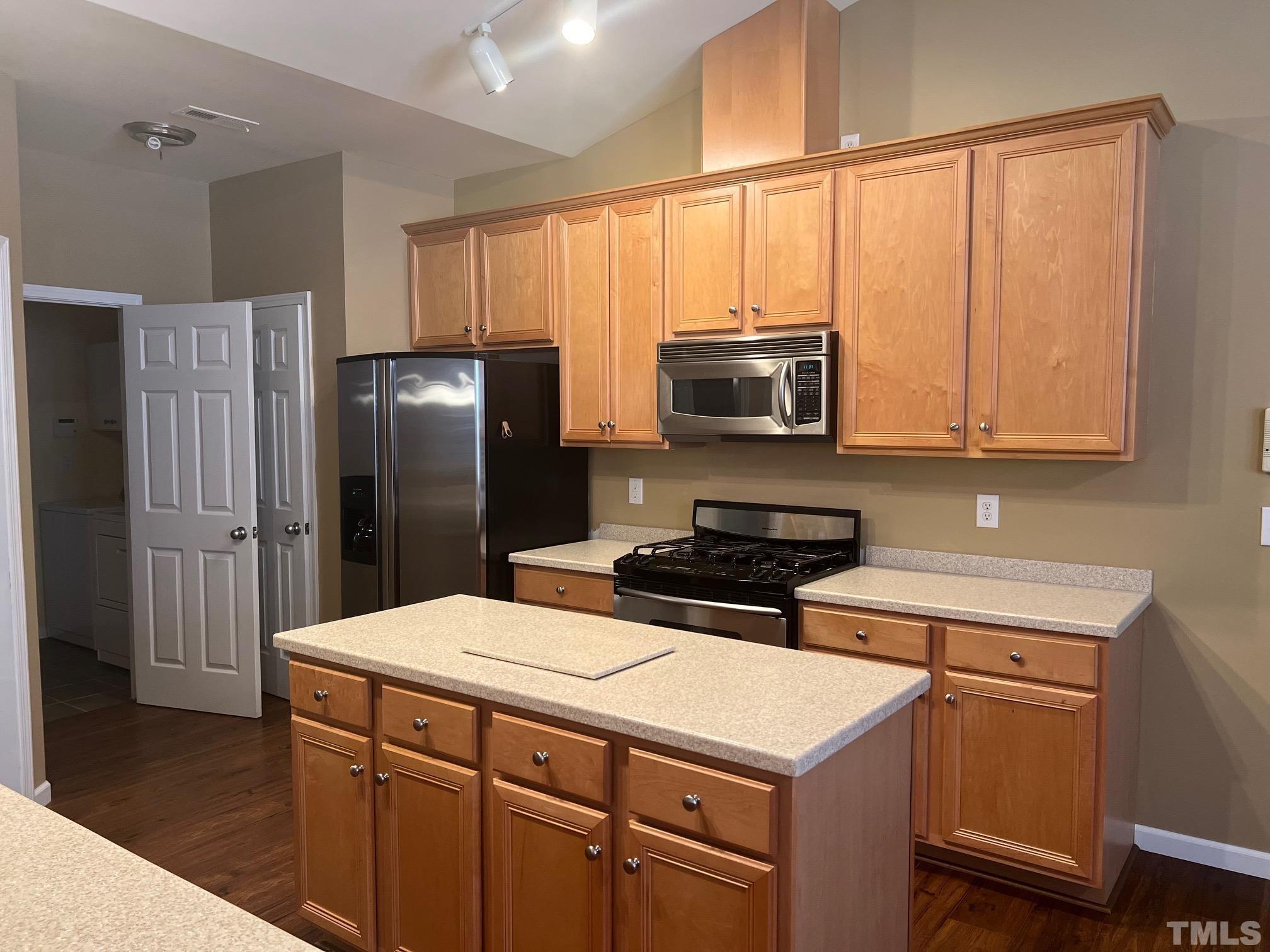 10527 Dapping Drive Raleigh, NC 27614 - Photo 7 of 20 a kitchen with a stove a refrigerator and a microwave