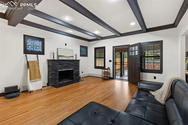 a living room with furniture large window and a fireplace